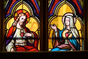 July 6, 2022; Sacred Heart of Jesus and Immaculate Heart of Mary in a detail from a stained glass window in the Lady Chapel of the Basilica of the Sacred Heart. (Photo by Matt Cashore/University of Notre Dame)